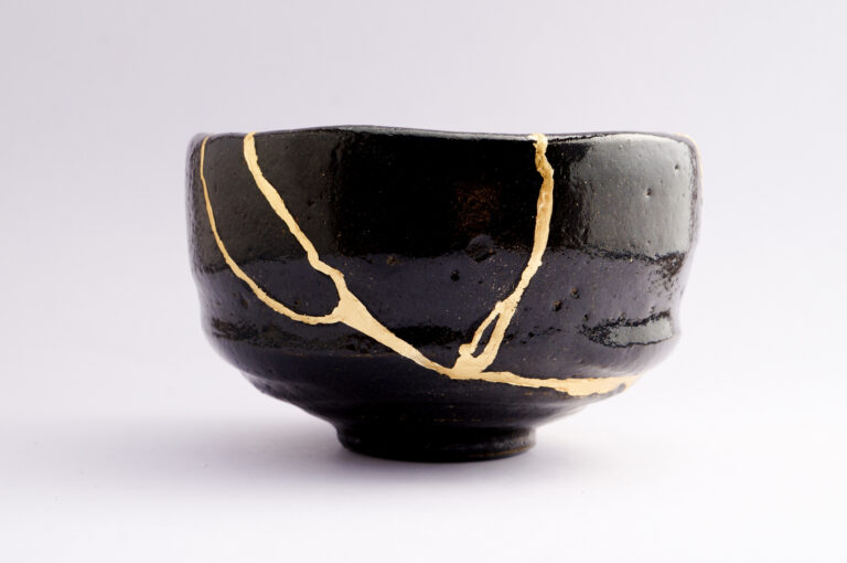 The art of Kintsugi showcased in beautifully repaired bowls with gold, highlighting Japanese craftsmanship and the beauty of imperfection.