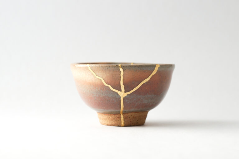 The art of Kintsugi showcased in beautifully repaired bowls with gold, highlighting Japanese craftsmanship and the beauty of imperfection.