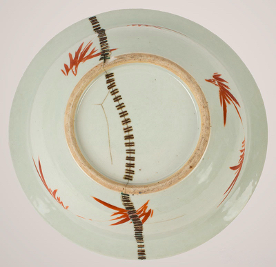 Bowl repaired using the metal staple Kintsugi method, with metal staples highlighting the cracks, combining traditional repair with a modern, industrial aesthetic