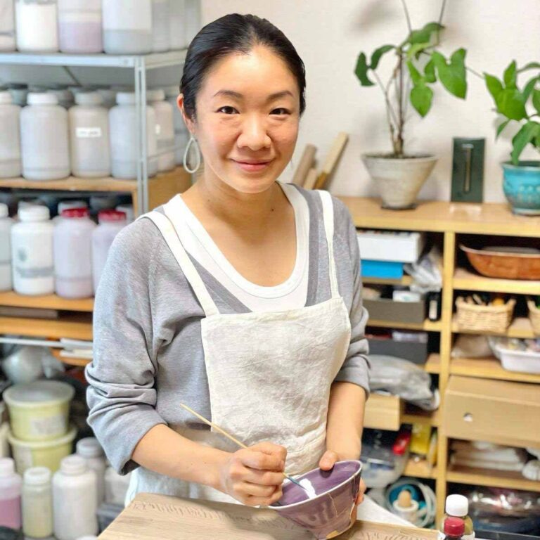 Tomomo Kamoshita, a skilled Kintsugi artist, showcasing the delicate art of repairing broken pottery with gold to highlight the beauty of imperfection