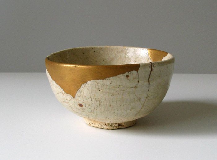 Bowl repaired using the piece-method Kintsugi technique, with carefully placed gold seams filling the cracks, highlighting the beauty of restoration and imperfection